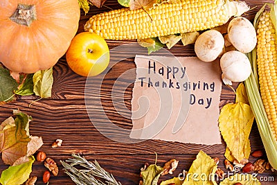 Autumn concept of vegetables view from above on a bag and brown wooden table. Thanksgiving day Stock Photo