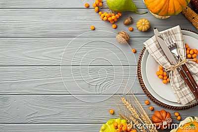 Thanksgiving day concept. Top view photo of table setting plate knife fork napkin vegetables pumpkins pear wheat walnut rowan Stock Photo