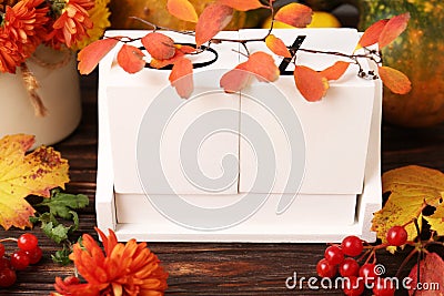 Thanksgiving day, holiday celebrated every fourth Thursday in November. Block calendar and autumn leaves on wooden table, closeup Stock Photo