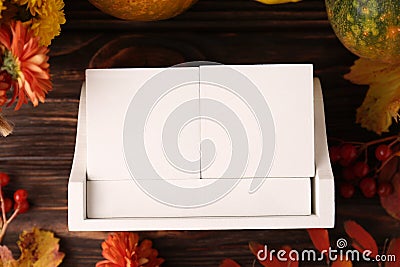 Thanksgiving day, holiday celebrated every fourth Thursday in November. Block calendar and autumn leaves on wooden table, flat lay Stock Photo