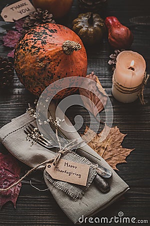 Thanksgiving decoration with cutlery and napkin on the wooden table. Stock Photo