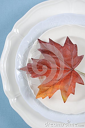 Thanksgiving dining table elegant place setting with autumn leaf - vertical. Stock Photo