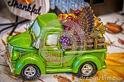 Thanksgiving farm truck table decoration - back filled with turkey and harvest produce - Give Thanks written on door -selective Stock Photo