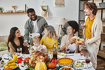 Thanksgiving feast, happy multiethnic friends and Stock Photo