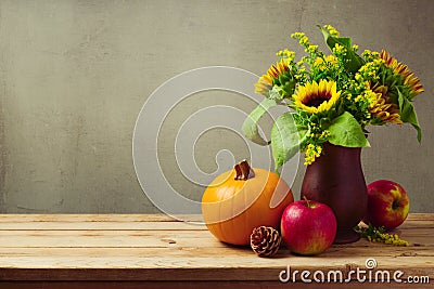 Thanksgiving holiday table decoration with sunflowers, pumpkin and apples Stock Photo
