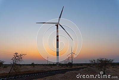 Thar desert, Rajasthan, India - 15.10.2019 : Pre dawn light in desert sky with Electrical power generating wind mills producing Editorial Stock Photo