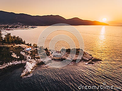 Thasos Beach Karnagio at sunset and Limenas town visible to the left Stock Photo