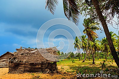 Thatched coconut leaf house or fishing hut on tropical beach Stock Photo