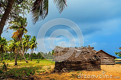 Thatched coconut leaf house or fishing hut on tropical beach Stock Photo