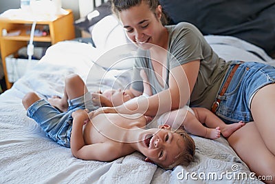 Thats ticklish, Mom. a young woman bonding with her two sons at home. Stock Photo