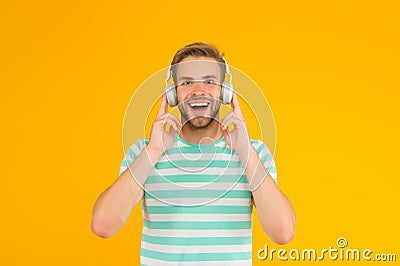 Thats what I call music. Happy guy listen to music yellow background. Handsome man enjoy music playing in headphones Stock Photo