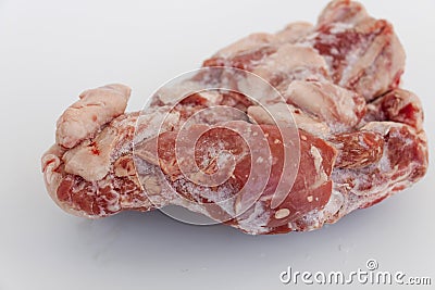 Thawing partly fatty piece of meat removed from the freezer on white background Stock Photo