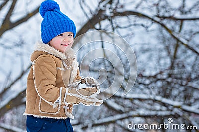 Theme Christmas holidays New Year. Winter snow and child game. Happy winter time for kid. Joyful little boy child Having Stock Photo