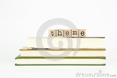 Theme word on wood stamps and books Stock Photo