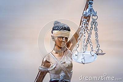 Themis figure on wooden background, close up Stock Photo