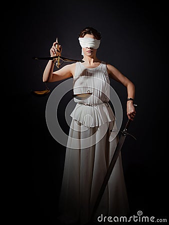 Themis, goddess of justice blindfolded, with scales and a sword in her hands. Stock Photo