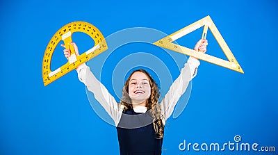 Theorems and axioms. Smart and clever concept. Girl with big ruler. School student study geometry. Kid school uniform Stock Photo