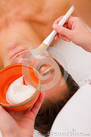 Therapist applying cream man's face Stock Photo