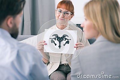 Therapist doing an inkblot test with her patients Stock Photo