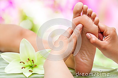 Therapist hands massaging foot. Stock Photo