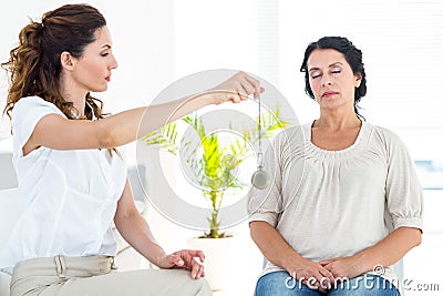 Therapist hypnotizing her patient Stock Photo