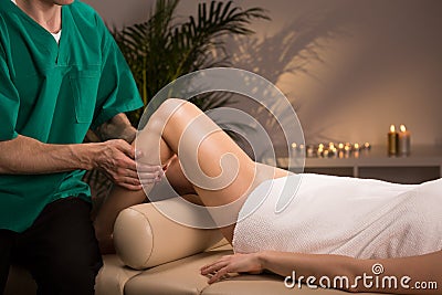 Therapist massaging female leg Stock Photo