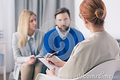 Therapist talking to a couple with problems Stock Photo