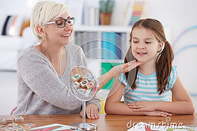 Therapist touching girl`s chin Stock Photo