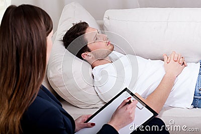 Therapist working with patient on hypnosis Stock Photo