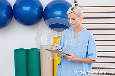 Therapist writing on clipboard Stock Photo