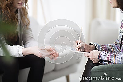 Therapist writing down notes Stock Photo