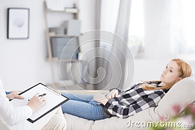 Therapist writing down notes Stock Photo