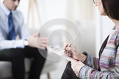 Therapist writing notes Stock Photo