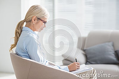 Therapist writing notes Stock Photo