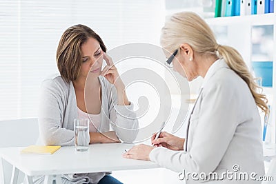 Therapist writing notes of patient Stock Photo