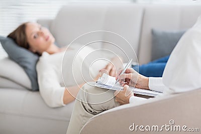Therapist writing notes of patient Stock Photo