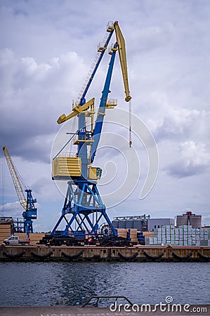 there is a crane in a transshipment port Editorial Stock Photo