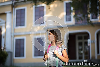 Little girl with school bag Stock Photo