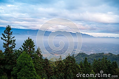 There are layers of white clouds floating over the valley villages. Stock Photo