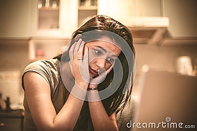 There is so much bad news online. Young woman using laptop. Stock Photo