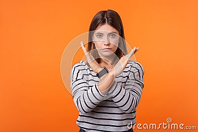 There is no way. Portrait of determined serious woman with brown hair in long sleeve striped shirt. indoor studio shot isolated on Stock Photo