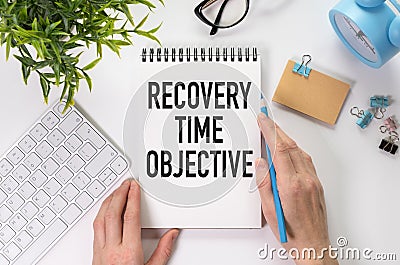 There is notebook with the word Recovery Time Objective. It is as an eye-catching image. Stock Photo