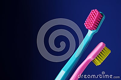 Two bright plastic toothbrushes on a dark blue background. There is a place for text. Stock Photo