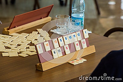There is a set for the game on the table. The game of logic is like a domino. Chips with numbers Stock Photo