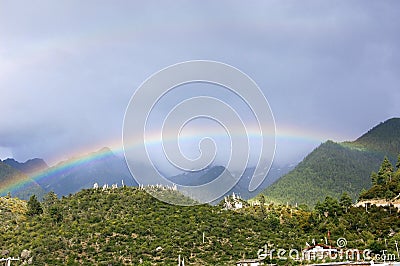 There are several cabins in the beautiful rainbow mountain in the sky after the rain Stock Photo