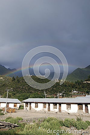 There are several cabins in the beautiful rainbow mountain in the sky after the rain Stock Photo