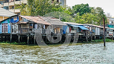 Wooden Water Houses Along The Riverside On The Chao Phraya River In Bangkok, Thailand Editorial Stock Photo