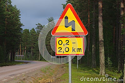Winding road ahead sign in Dalarna Stock Photo