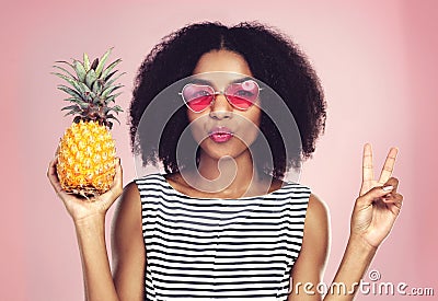 Theres so much beauty in being different. Studio shot of a beautiful young woman posing with a pineapple. Stock Photo