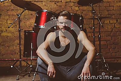 Theres music in the air. Enjoying instrumental music. Handsome man sit on stage at percussion instrument. Man drummer Stock Photo